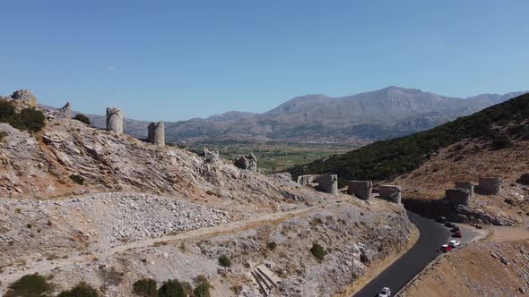 Mills in Motion on Mountain Peak By Mediterranean Sea Crete Greece alt
