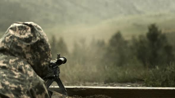 Super slow motion shot of soldier shooting chain gun; training at firing range. alt