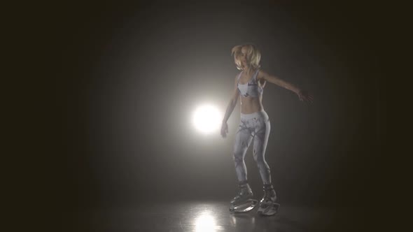 Girl Doing Exercises in Kangoo Jumps Shoes in Haze, Slow Motion alt