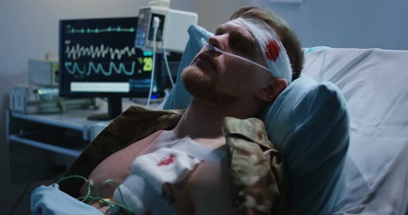 Man Lying in Hospital Bed with Head Injury alt