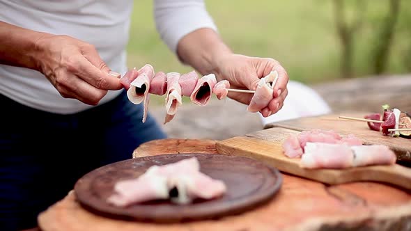 Assembling pork, prosciutto and prune kebabs alt