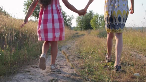 Two little girls walking on rural road