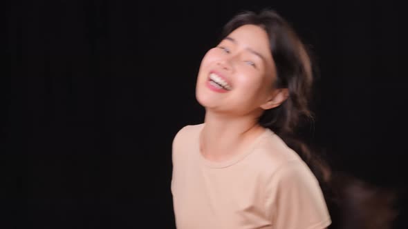 Asian woman laughing and being playful alt