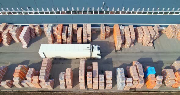 Truck on the territory of an industrial warehouse alt