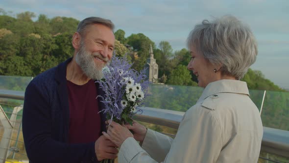Portrait of Cheerful Seniors Having Date in City Park alt