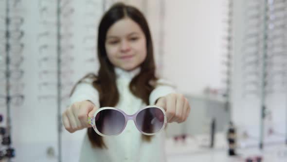 A Darkhaired Girl in a Cute White Cardigan and Shirt Holds in Front of the Camera and Then Puts on alt