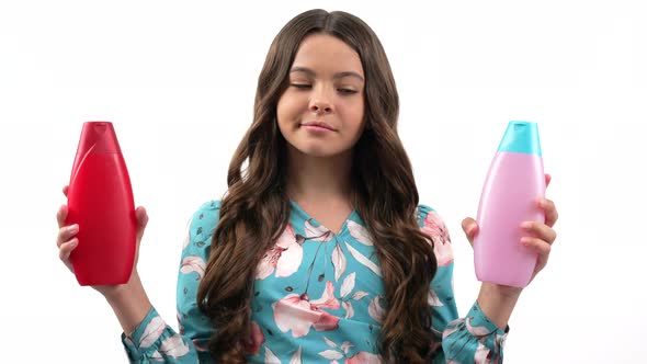 Smiling Kid Girl Choosing Product of Skin Lotion or Shower Gel in Bottle Conditioning Treatment alt