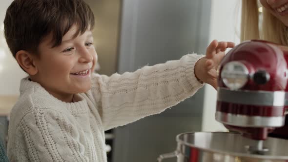 Video of children helping mother with Christmas baking. Shot with RED helium camera in 8K. alt