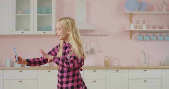 Cute Girl Recording Video of Modern Dancing for Popular Social Network. Kid Making Video for Mobile alt