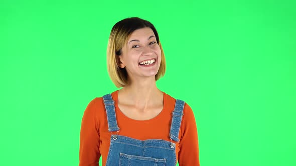 Lovely Girl Smiles Broadly and Winks. Green Screen alt