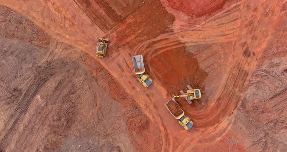 Excavator and Trucks Working on the Excavation Works of a Road Moving Earth alt