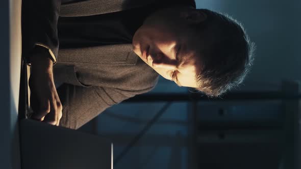 Night Work Business Man Using Laptop Dark Vertical alt