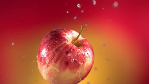 Flying of Red Apple in Red Yellow Background in Slow Motion alt