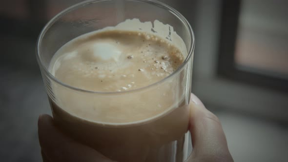 Fresh made latte being finished with milk foam alt