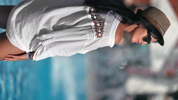 VERTICAL VIDEO POV Stylish Elegant Woman in White Shirt Sunbathing at Beach Waterfall Slow Motion alt