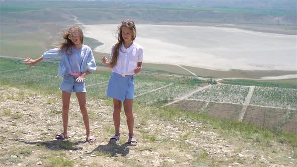 Children on Vacation on White Rock Background