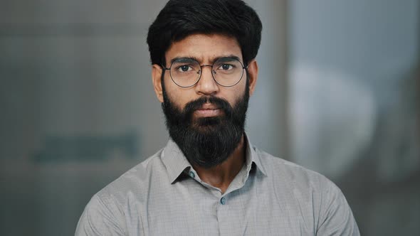 Portrait of Serious Handsome Arabic Hispanic Young Male Bearded Guy in Eyeglasses Wear Shirt Stands alt