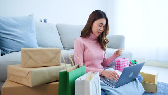 Asian attractive woman enjoy shopping online use laptop purchase goods or product in website. alt