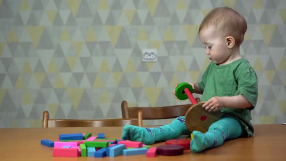 a Little Girl Is Sitting on a Table and Playing with Toys