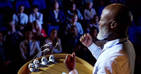 African American businessman speaking in business seminar in auditorium 4k alt