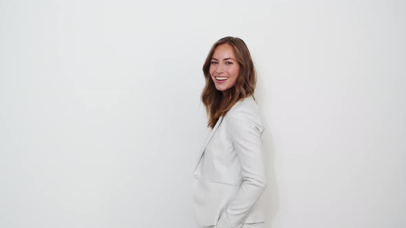 Businesswoman Smiling in White Suit