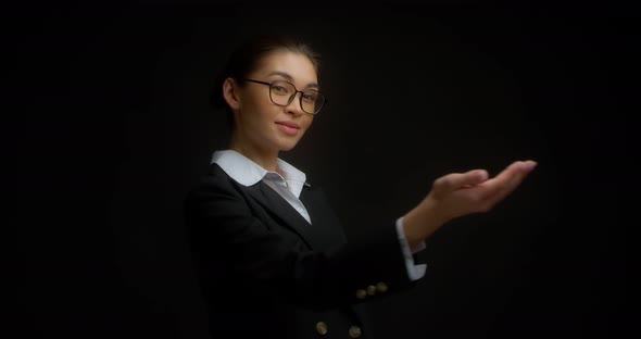 Asian Woman in Business Clothes and Glasses Shows a Hand Gesture Come Here