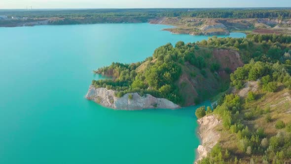 An artificial lake in chalk quarry. view from drone. Turquoise water background alt