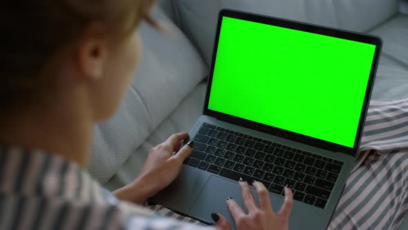 Woman Waving Green Laptop at Home Closeup alt