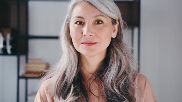 Portraits of a Gray Long Hair Asian Matured Happy Multiracial Smiling Woman alt