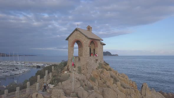 Alassio chapel and Gallinara island aerial drone view alt