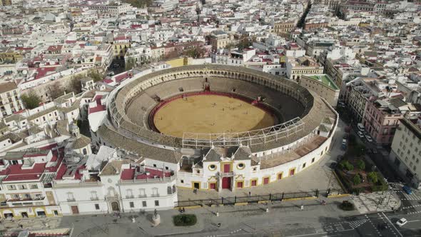 Descending drone view of iconic Maestranza bullfighting ring in Seville, Spain