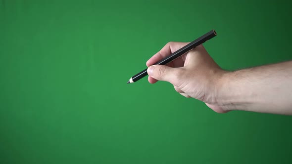 Man Holding Pencil In His Hand Isolated On Chroma Key Green Screen Background alt