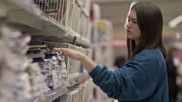 Young Woman Buys Notebooks From the Stationery Department