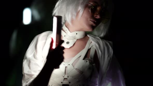 Closeup of a Blonde in a White Suit Doing Dance Moves Standing Isolated in the Studio in Front of a alt