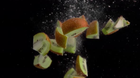 Kiwi Pieces Falling into Water Super Slowmotion, Black Background, lots of Air Bubbles, 4k240fps alt