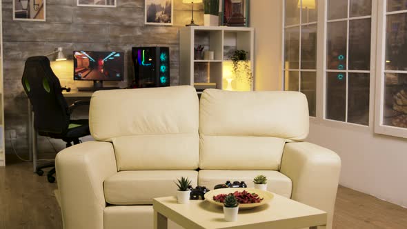Empty Room with Couch in the Middle and Gaming Computer Late at Night alt