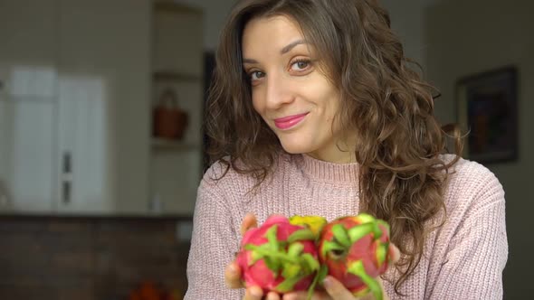 Young Girl is Holding Two Fresh Ripe Organic Dragon Fruits or Pitaya Pitahaya alt