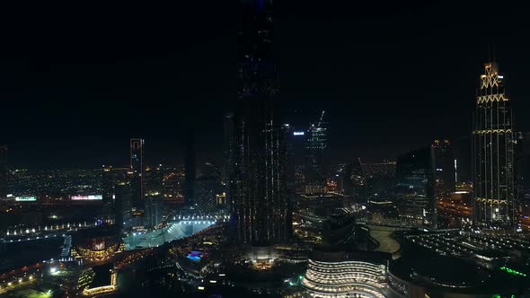 Aerial view of Burj Khalifa Tower with a light show at night in Dubai. alt