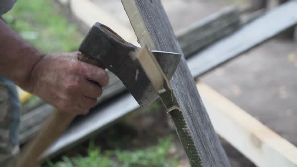 The Carpenter Cuts Off the Edge of the Board with a Sharp Ax.
