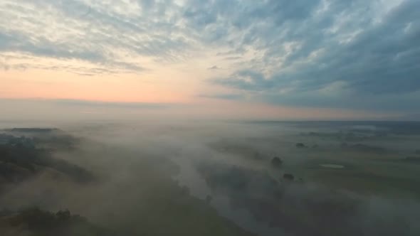 Aerial Shot of Beautiful Countryside Environment in Early Morning. Amazing Scenic View on Misty