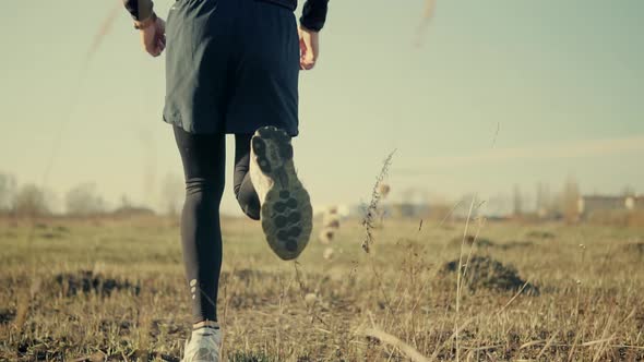 Triathlete Sport Recreation Run Workout On Sunset. Runner Silhouette Jogging At Dusk On Trail. alt