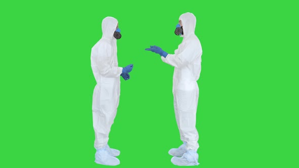 Two Doctors Giving High Five After a Successful Talk on a Green Screen, Chroma Key. alt