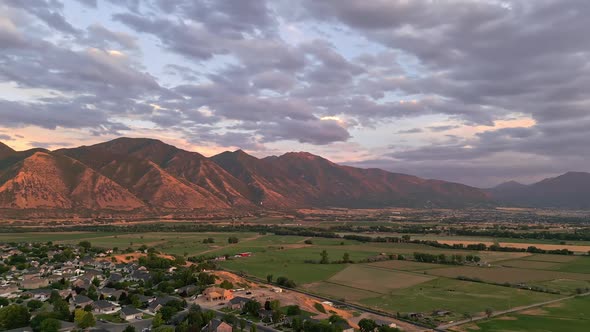 Rotating aerial view wear farmland and city meets in Spanish Fork, Utah alt