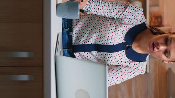 Vertical Video: Business Woman Working From Home Drinking Coffee alt