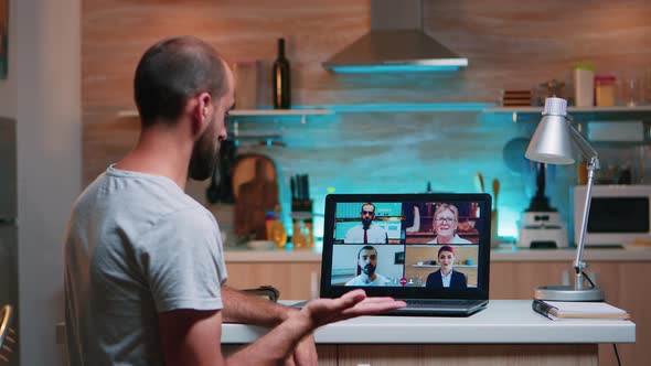 Employee Working Remotely Discussing with Partners Online alt