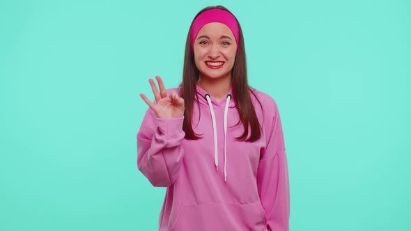 Countdown to Win Celebration Cheerful Girl 20s in Hoodie Counting in Reverse Order From Five to One alt