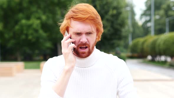 Angry Man with Red Hairs Talking on Phone at Work, Outdoor alt