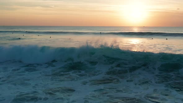 Following large waves at sunset