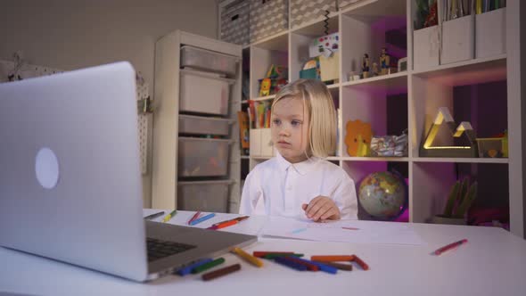 Distance Learning Online Education. A Small Teen Boy Study Online with Internet Teacher at Home.