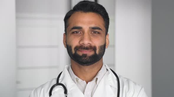 Indian Middle Age Male Doctor in Uniform with Stethoscope Looking at Camera